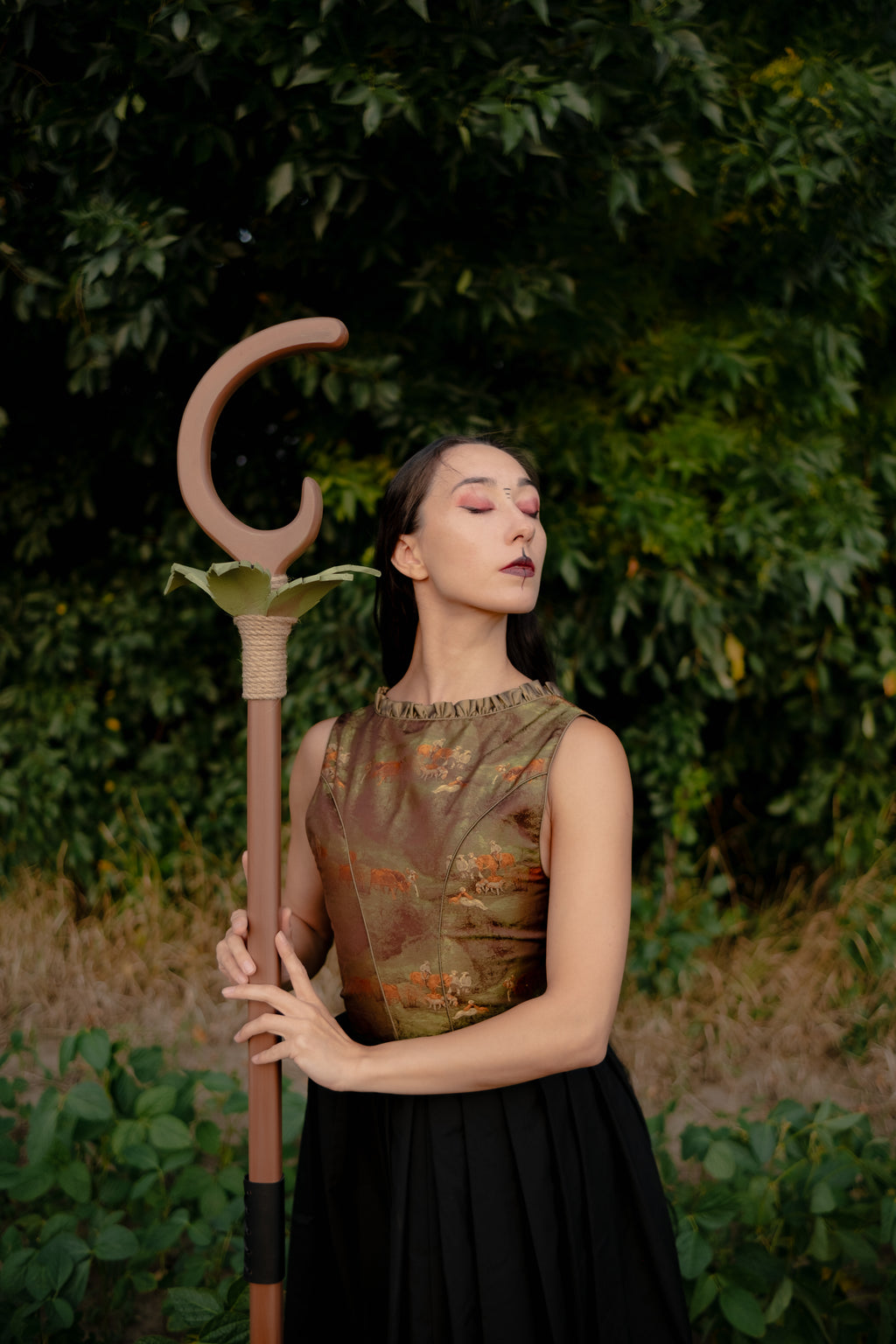 Leafbound Crescent handmade wooden staff with green EVA foam leaves on forest background