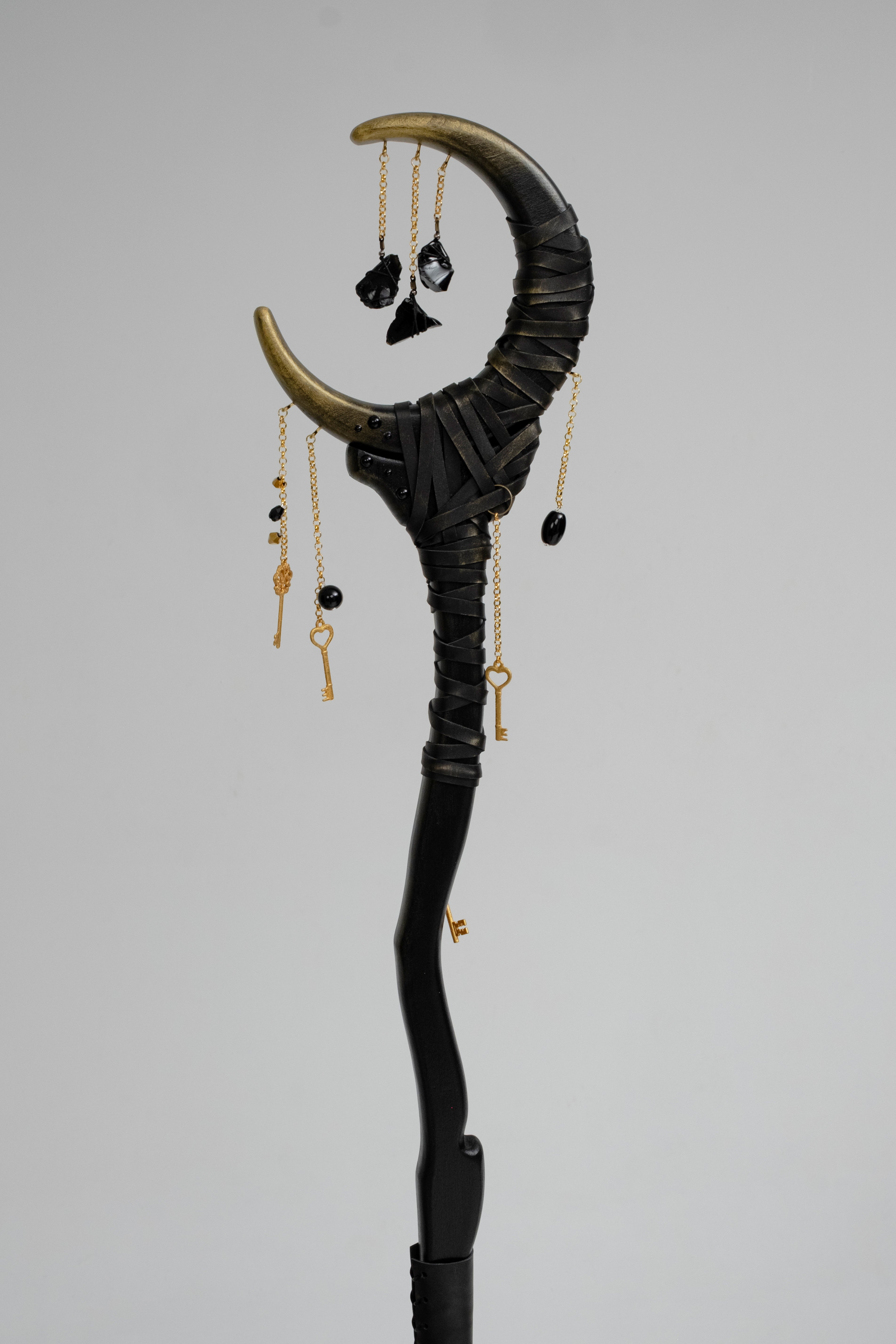 Crescent wizard staff with symbolic details