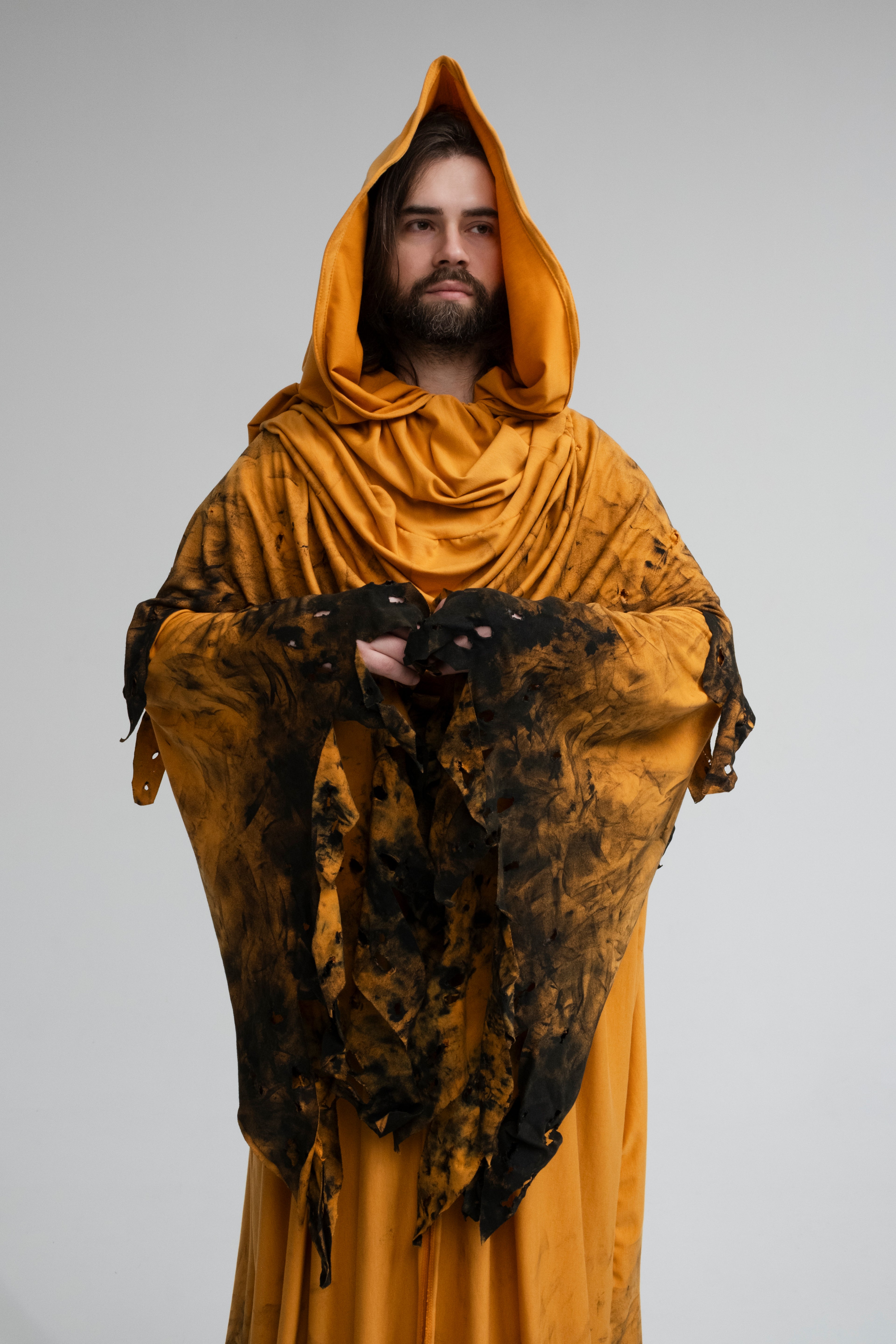 Long flowing yellow hooded cloak with distressed edges