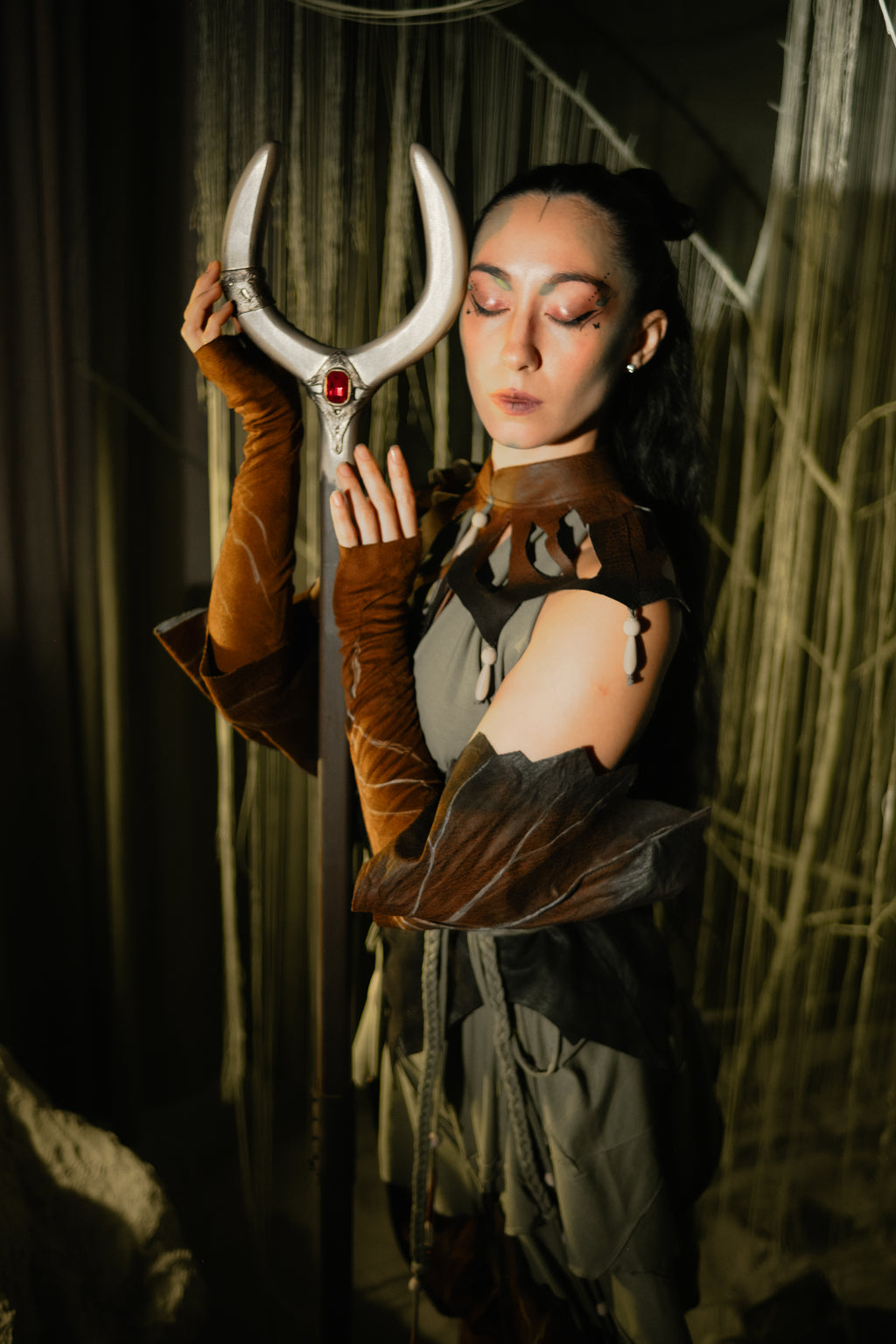 Handmade wooden crescent staff paired with brown and grey fantasy costume