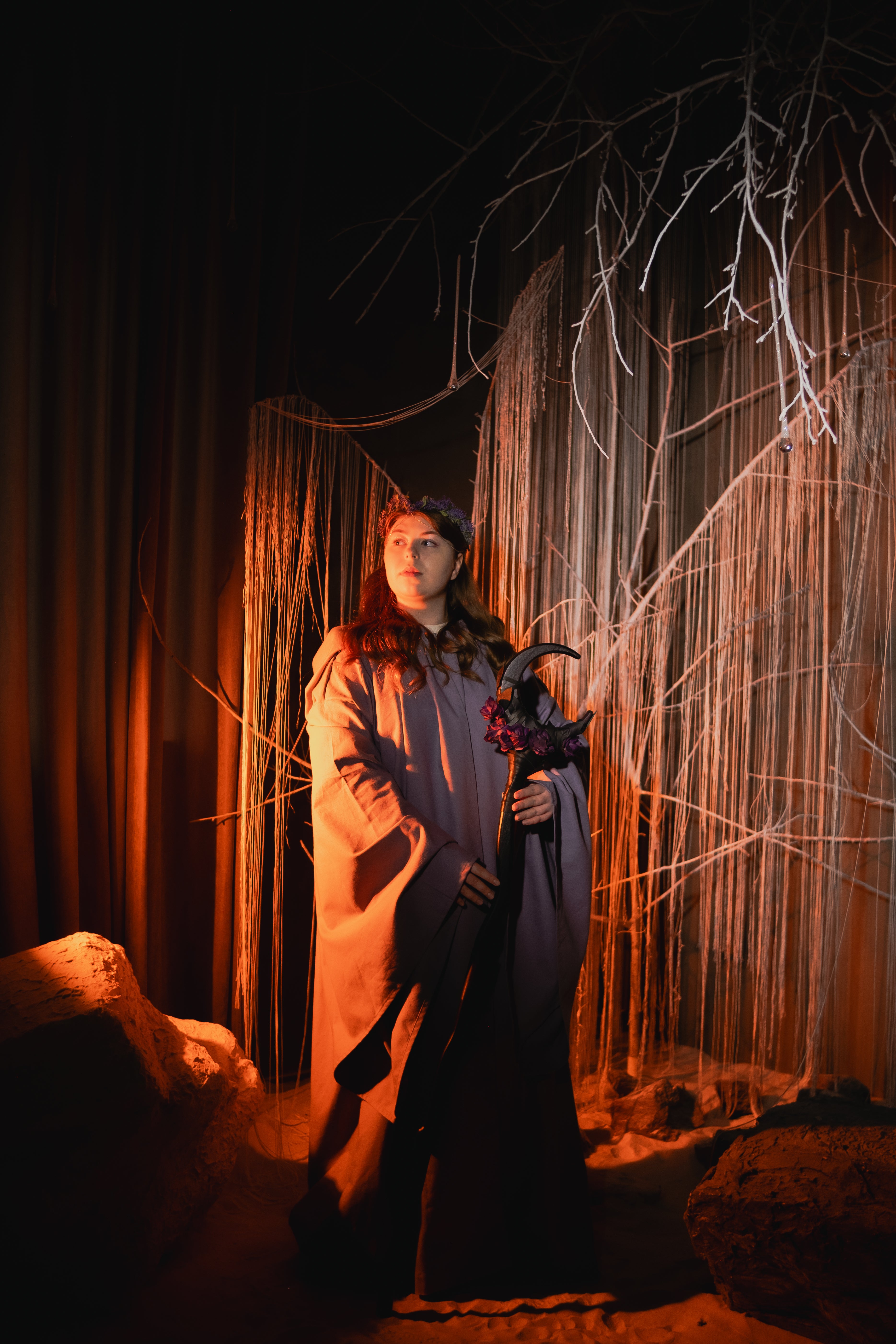 Handmade wooden crescent staff decorated with purple flowers