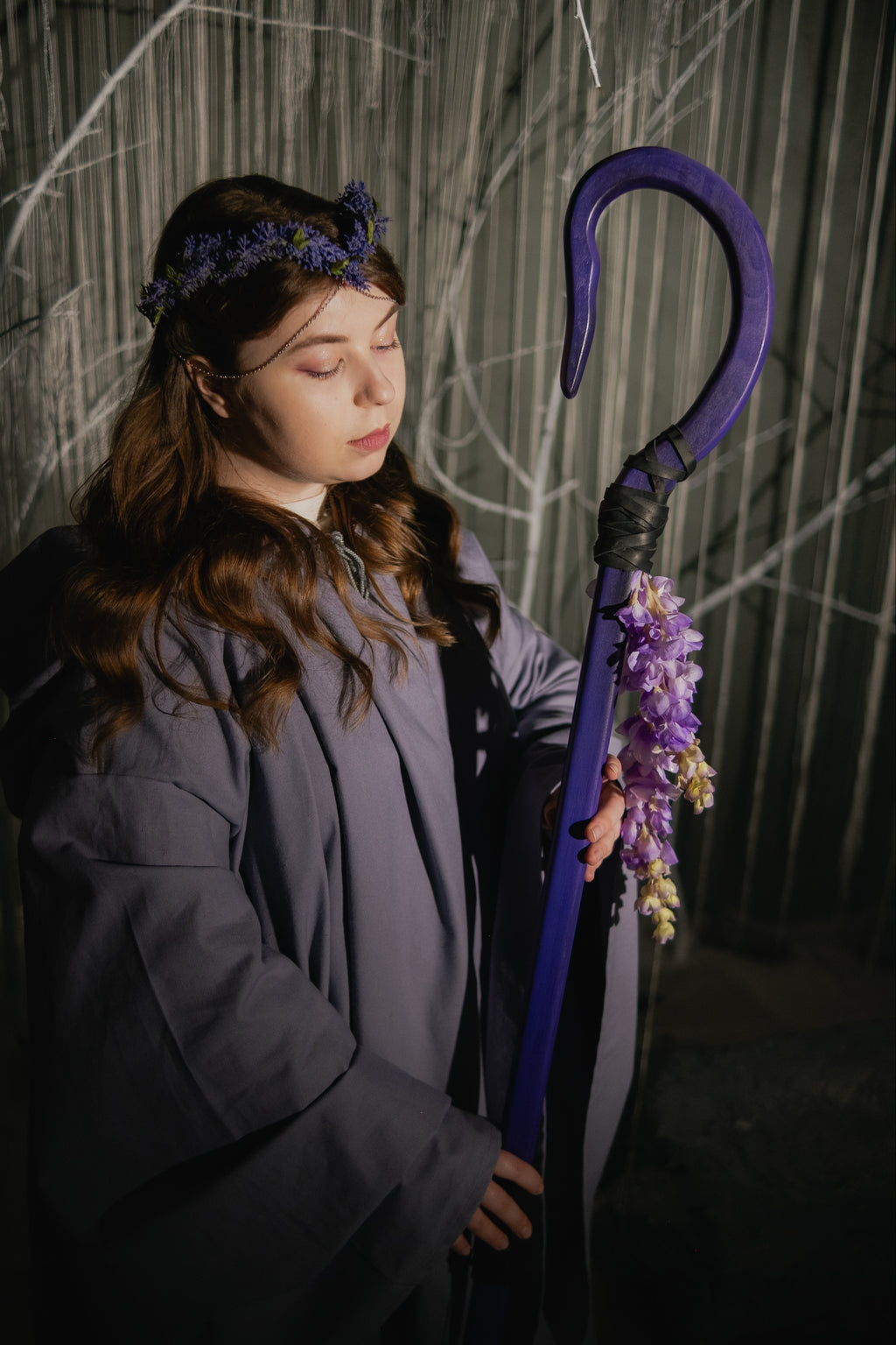Handmade purple staff with curved top and hanging flower details