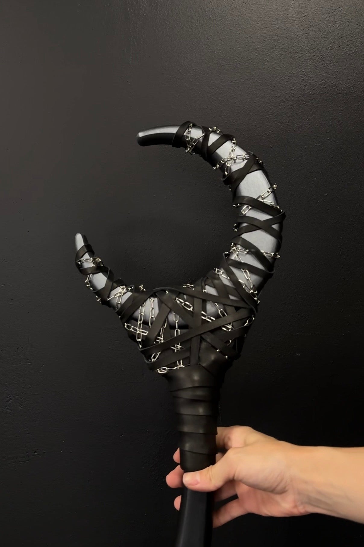 Detail of Gun Metal Chained Crescent Moon Staff with chain and shadow-toned finish